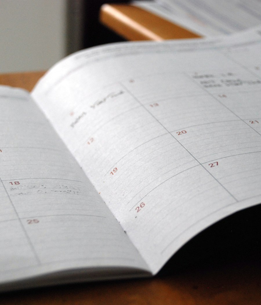 An open paper appointment diary on a desk